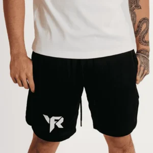 Man wearing black shorts and white shirt.